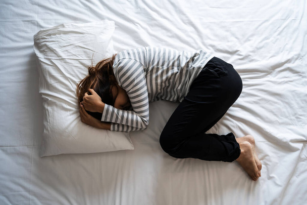 Lonely young woman depressed and stressed on the bed, Negative emotion and mental health concept - Valokuva, kuva