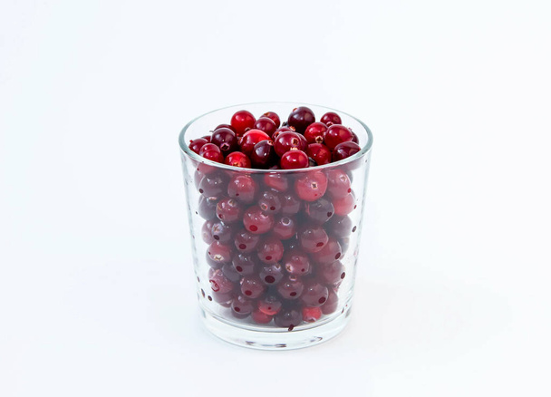 Red cranberries in a glass beaker on a white background. - Photo, Image