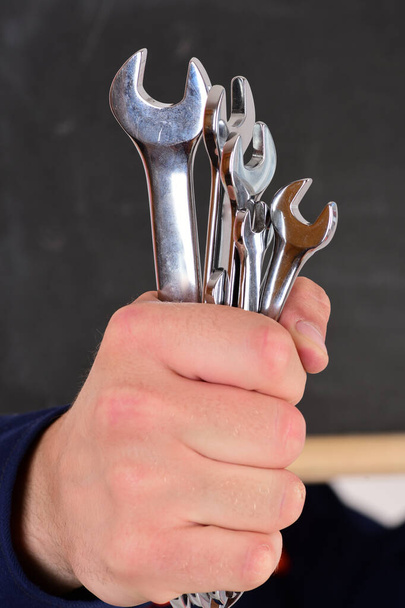 Repairer or mechanic hand holds spanner instrument. - Fotografie, Obrázek