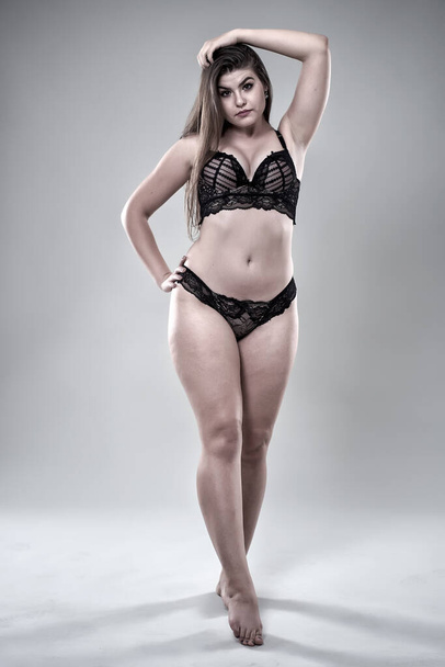 Plus size glamour model in black lingerie, monochrome toned - Фото, зображення