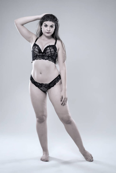 Plus size glamour model in black lingerie, monochrome toned - Foto, afbeelding