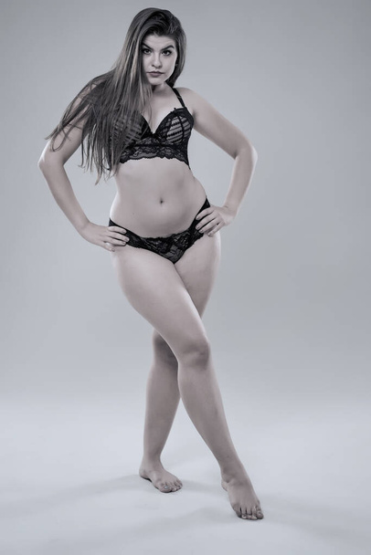 Plus size glamour model in black lingerie, monochrome toned - Fotó, kép