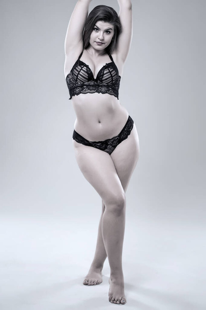 Plus size glamour model in black lingerie, monochrome toned - 写真・画像