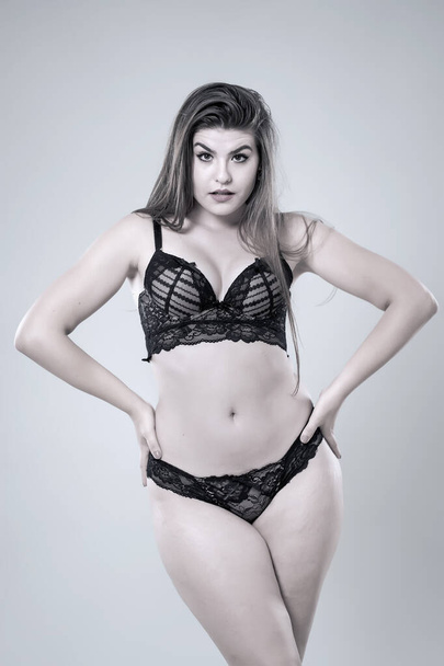 Plus size glamour model in black lingerie, monochrome toned - Foto, imagen