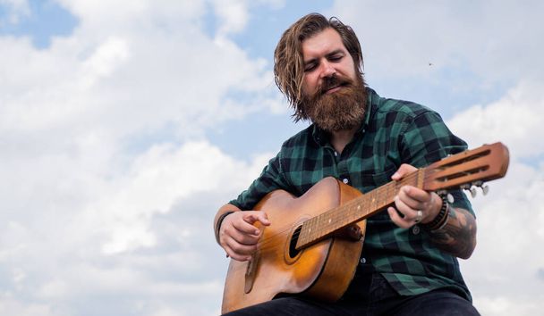 ranch guy. country music. bearded man singing song. handsome man singer and guitarist. acoustic guitar player. mature hipster musician with beard. brutal caucasian guy playing guitar - Photo, Image