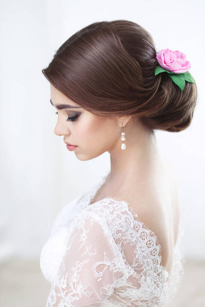 Portrait of a beautiful brunette bride with make-up and hairstyle in lace top view - Photo, image