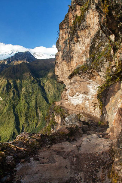 pathway and rock face, Mount Saksarayuq, Andes mountains, Choquequirao trekking trail near Machu Picchu, Inca trail, Cuzco or Cusco region in Peru  - Photo, image