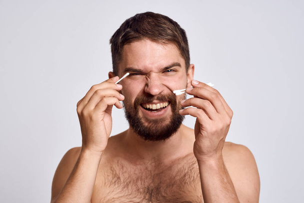 Baard man met blote schouders katoen wattenstaafjes hygiëne lichaamsverzorging - Foto, afbeelding