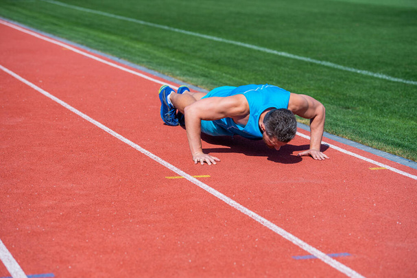 muscular man stand in plank making push up on sport training, success - Foto, imagen