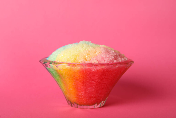 Rainbow shaving ice in glass dessert bowl on pink background - Fotoğraf, Görsel