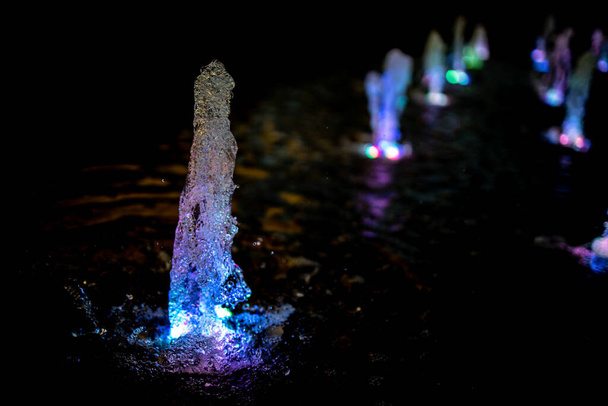 beautiful fountain with colorfully lit in the evening - Fotoğraf, Görsel