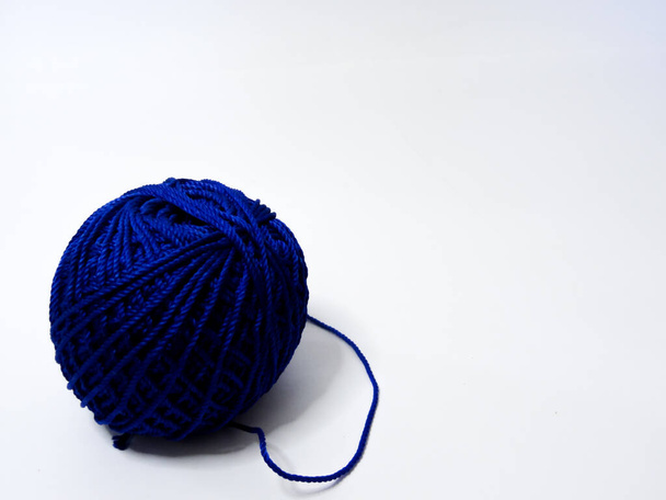 blue knitting yarn on a white background - Fotoğraf, Görsel