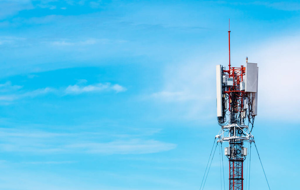 Telecommunication tower with blue sky and white clouds background. Antenna on blue sky. Radio and satellite pole. Communication technology. Telecommunication industry. Mobile or telecom 4g network. - Photo, Image