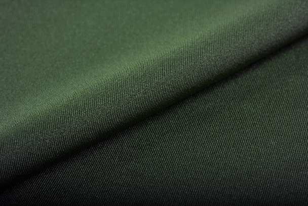 green Knitted elastic fabric, weaving of threads texture, crumpled fold. For underwear, sports clothes and swimwear. Space for text. - Fotografie, Obrázek