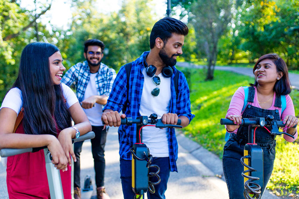 modern indian friends ride on segway in park in India - Foto, afbeelding