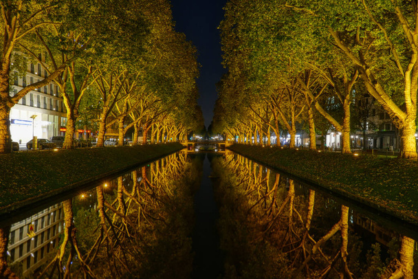 Water canal of the shopping mile in Dusseldorf at night - Photo, Image