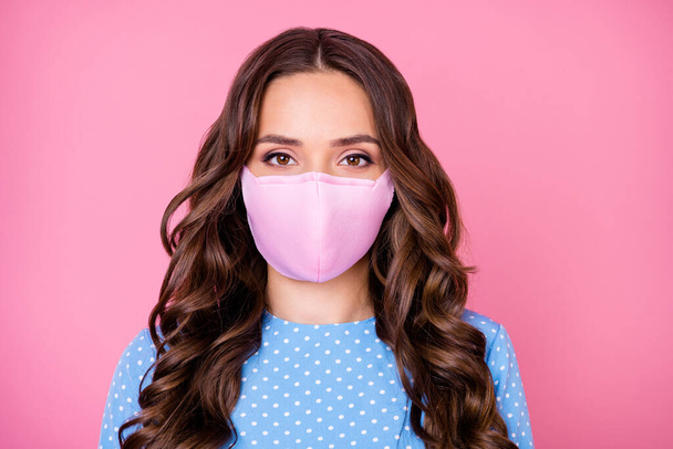 Close-up portrait of her she attractive lovely pretty wavy-haired lady wearing safety reusable cotton textile mask contamination 2019-ncov flu grippe syndrome isolated pink pastel color background - Фото, изображение