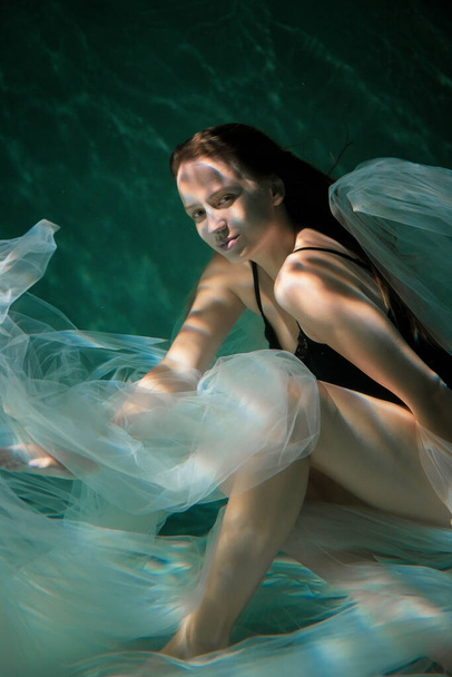 Young Slender Girl Underwater with a Cloth. Water Magic. Underwater Photography. Art - Φωτογραφία, εικόνα