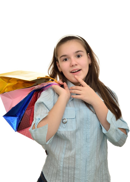 Teen girl with multicolored packages in hands rejoices - Photo, Image