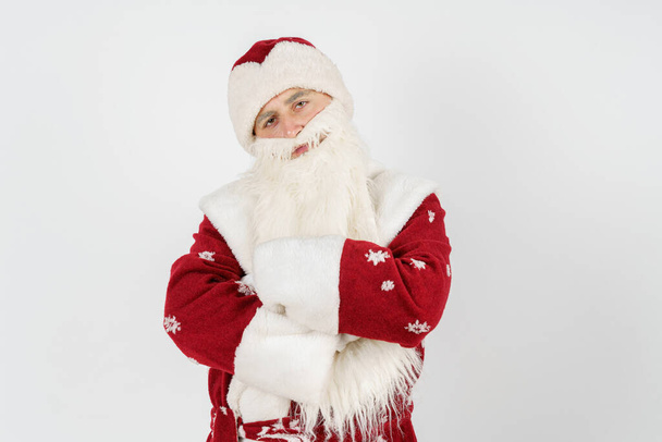 New Year and Christmas concept. Portrait of Santa Claus, folded his arms in front and looking at the camera. - Фото, изображение