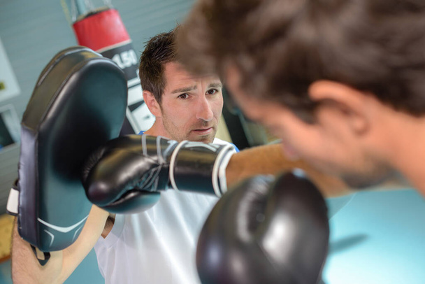 a man boxing with his trainer - Fotoğraf, Görsel