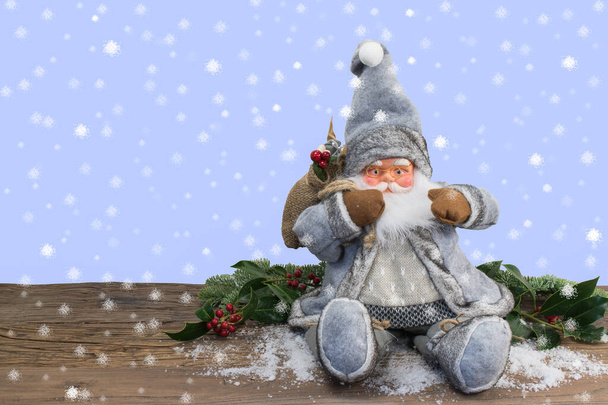 Santa Claus doll on snow background. - Photo, Image