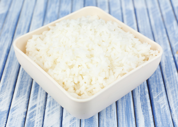 Cooked rice in bowl on wooden background - Fotografie, Obrázek