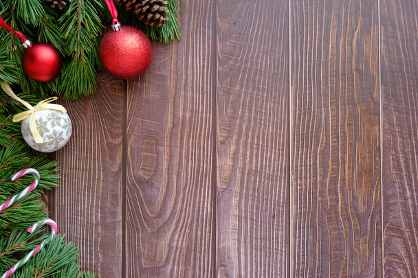 Christmas background with fir tree and decoration on wooden board - Φωτογραφία, εικόνα