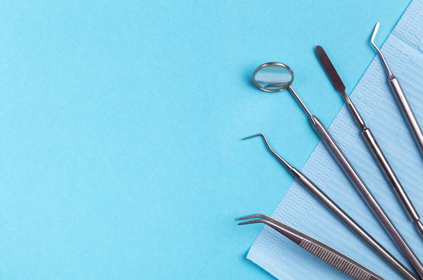 Set of dental instruments on a blue background. - Photo, image