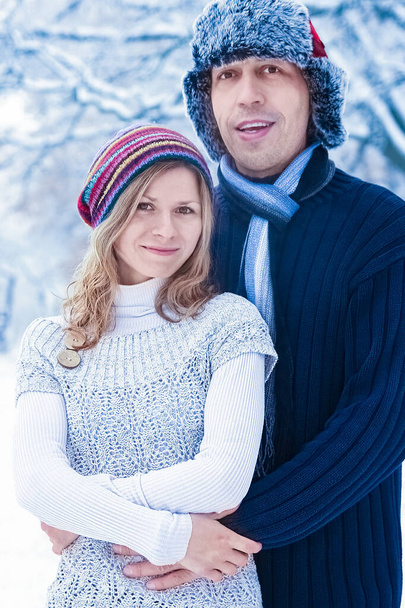 Stylish beautiful couple in winter park on a nature background - Фото, зображення