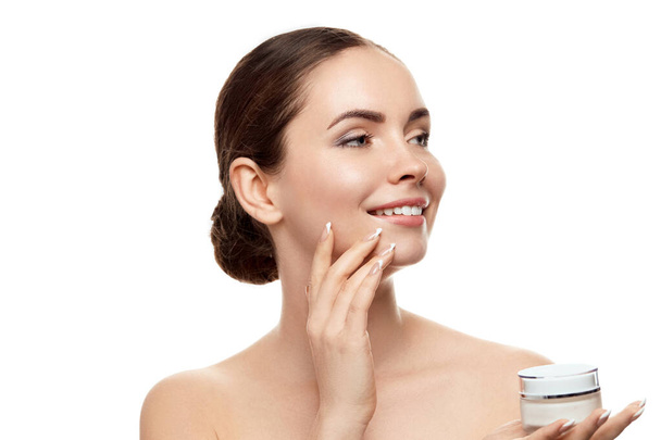 Beautiful Woman holdinging  moisturizing cream . Cosmetics. Portrait of female with clean  skin. Skin Care. Facial treatment. Cosmetology, beauty and spa - 写真・画像