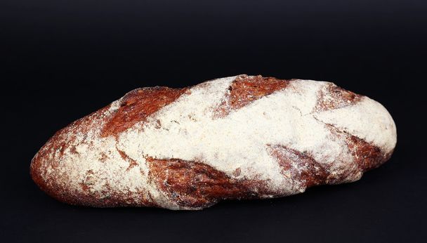 Loaf of bread on black background - Фото, зображення