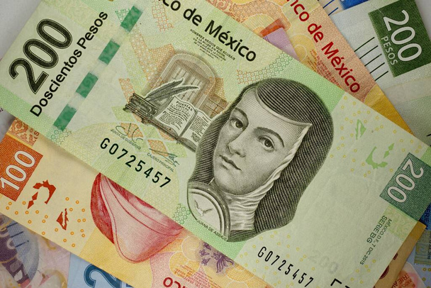 Mnoho mexických pesos bankovek se náhodně rozprostřelo po plochém povrchu - Fotografie, Obrázek