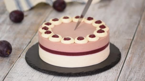 Cutting delicious plum mousse cake with whipped cream. - Footage, Video