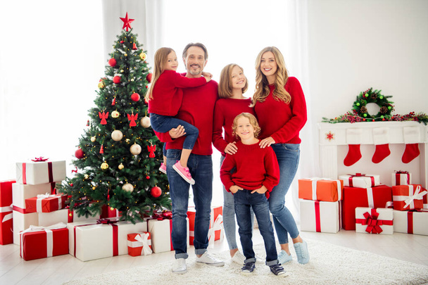 Full length photo of big family five people meeting lovers three little kids father hold embrace daughter wear red sweater jeans in living room x-mas tree many gift boxes indoors - Fotó, kép