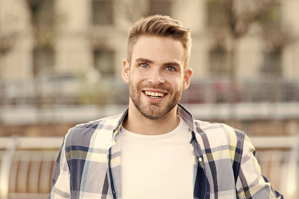 Just happy. Handsome male portrait. Facial hair and skin care concept. Handsome face. Handsome man unshaven face and stylish hair. Caucasian man urban background. Relaxed bearded man casual style - Φωτογραφία, εικόνα