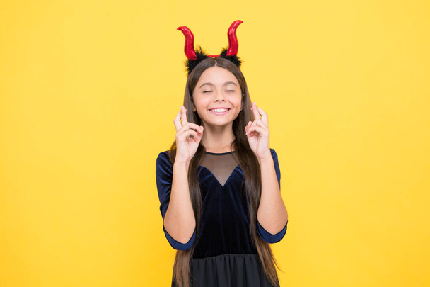 happy kid wear devil horns costume on halloween party making a wish, halloween dream - Foto, Bild