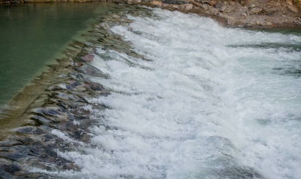 cascade of water that overflows from the dam - Photo, Image