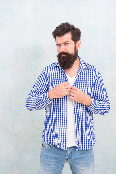 Brutal hipster with bearded face skin button fashion plaid shirt in casual style blue background, fashionable - Foto, imagen