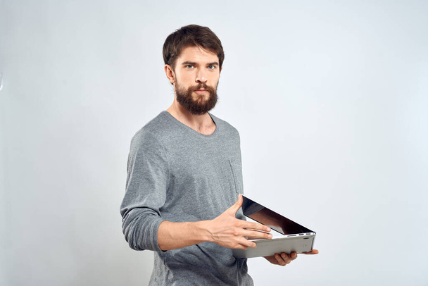 Emotional man holding a laptop success modern style work light background - Fotoğraf, Görsel