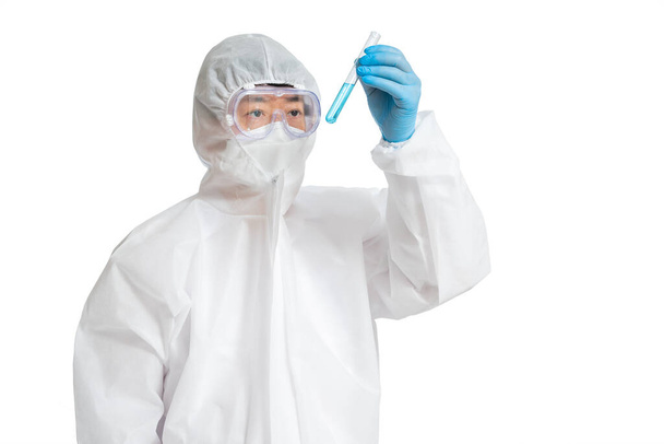 An Asian man wearing a protective suit, protective face masks, and safety glasses on a white background. - Valokuva, kuva