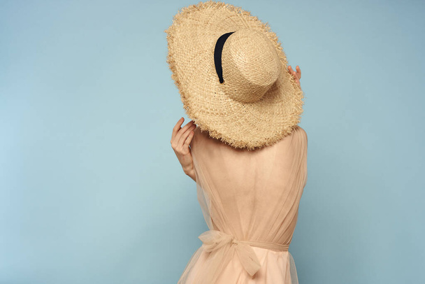 Woman in hat with naked back on blue background model back view - Foto, Imagem