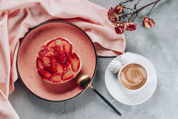 Cup of coffee and cake with strawberries on gray table, top view. High quality photo - Photo, image