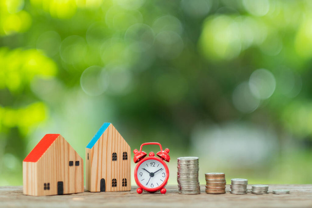 miniature house model with coins on wood background - Photo, Image