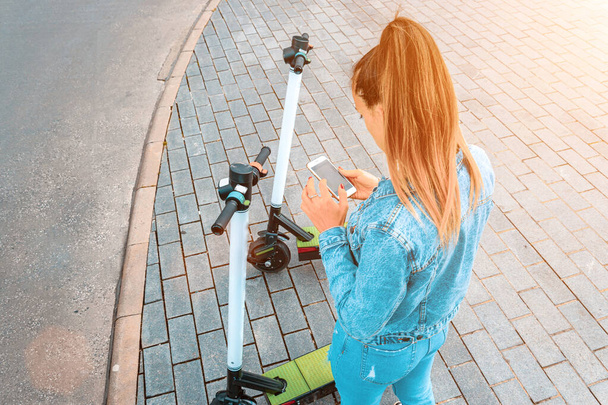 Transporte eléctrico: patada scooter eléctrico de la ciudad usando de chica. Estilo de vida urbano. Concepto de transporte urbano eléctrico. - Foto, Imagen