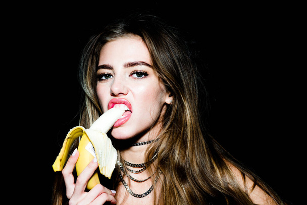 Sensual young woman eating banana. Tropical fruits. Healthy eating. Beautiful and sexy elegant young girl. Sexy sweet dreams. - Fotoğraf, Görsel