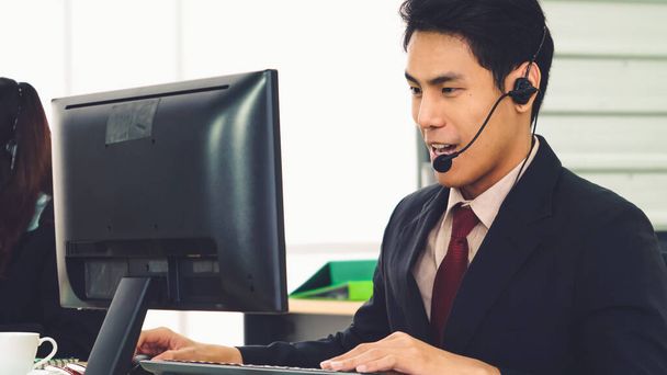Business people wearing headset working in office - Foto, imagen