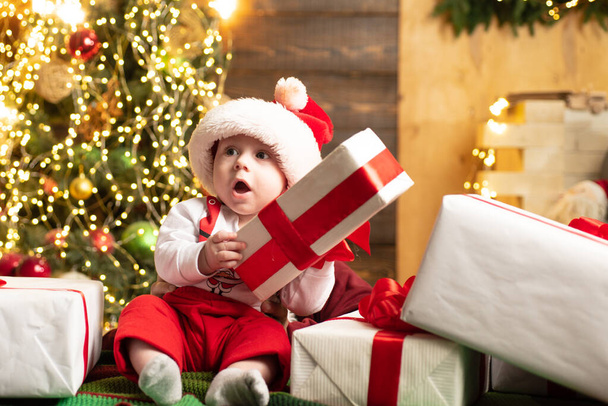 Amazed attractive baby in the Christmas costume. - Fotó, kép