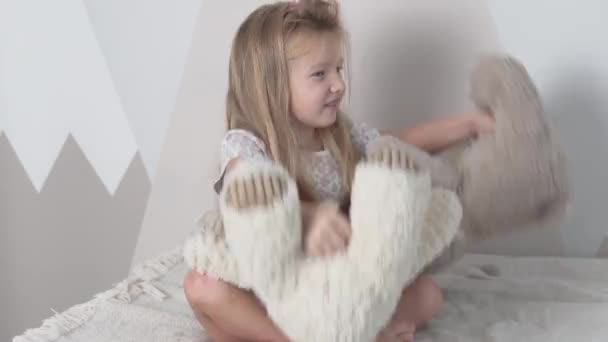 Kaunis pieni tyttö leikkii hänen nallekarhuja aamulla - Materiaali, video