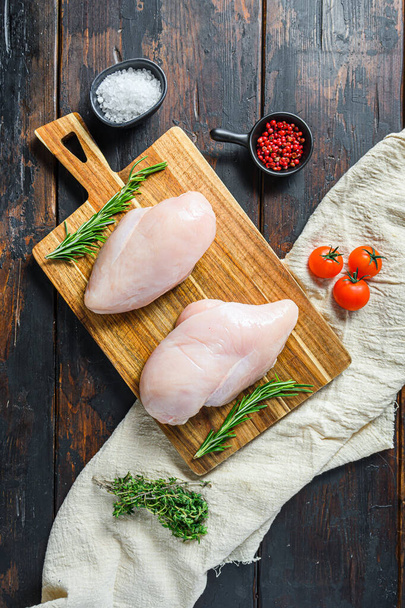 Raw chicken breast on wood background. Food preparation. Top view - Photo, Image